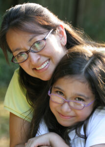 Mother and child wearing glasses and posing for photo